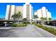 Condo building with lush landscaping and parking at 19 Whispering Sands Dr # 1204, Sarasota, FL 34242