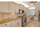 Bright kitchen features updated cabinetry and tile backsplash at 19 Whispering Sands Dr # 1204, Sarasota, FL 34242