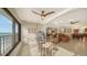 Bright living room with ocean view, glass table and seating at 19 Whispering Sands Dr # 1204, Sarasota, FL 34242