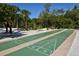 Two shuffleboard courts nestled in a lush, tropical setting at 19 Whispering Sands Dr # 1204, Sarasota, FL 34242