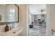 Small bathroom with pedestal sink and view into home office at 2402 Palmetto St, Nokomis, FL 34275