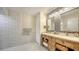 Bathroom with double vanity, hexagon tile, and decorative mirrors at 2402 Palmetto St, Nokomis, FL 34275
