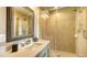 Modern bathroom with a walk-in shower, updated vanity, and a large mirror at 2402 Palmetto St, Nokomis, FL 34275