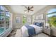 Spacious bedroom with large windows, plush bedding, and a wooden nightstand at 2402 Palmetto St, Nokomis, FL 34275