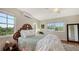 Bedroom with a full-size bed, hardwood floors, and large windows at 2402 Palmetto St, Nokomis, FL 34275