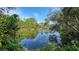 Scenic view of a tranquil canal with lush greenery at 2402 Palmetto St, Nokomis, FL 34275