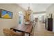 Elegant dining room with a farmhouse table and view to the living room at 2402 Palmetto St, Nokomis, FL 34275