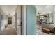 Bright entryway with light teal door opening to a home office and living area at 2402 Palmetto St, Nokomis, FL 34275