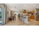 Open kitchen with island, stainless steel appliances, and wooden cabinets at 2402 Palmetto St, Nokomis, FL 34275