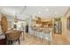 Open kitchen with island, stainless steel appliances, and wooden cabinets at 2402 Palmetto St, Nokomis, FL 34275