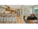 Open kitchen with island, stainless steel appliances, and wooden cabinets at 2402 Palmetto St, Nokomis, FL 34275