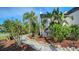 Landscaped walkway with tropical plants and a rock border at 2402 Palmetto St, Nokomis, FL 34275