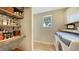 Laundry room with washer, dryer, and ample storage shelving at 2402 Palmetto St, Nokomis, FL 34275