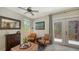 Cozy living room with two armchairs, a coffee table, and access to a patio at 2402 Palmetto St, Nokomis, FL 34275