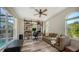 Home office with built-in shelving, large windows, and comfortable seating at 2402 Palmetto St, Nokomis, FL 34275