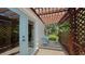Relaxing patio with pergola, lattice, and small table and chairs at 2402 Palmetto St, Nokomis, FL 34275