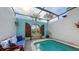 Inviting pool area with a covered patio and comfortable seating at 2402 Palmetto St, Nokomis, FL 34275
