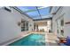 Relaxing, rectangular pool surrounded by a tiled patio at 2402 Palmetto St, Nokomis, FL 34275