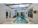 Enclosed private pool with covered patio and seating area at 2402 Palmetto St, Nokomis, FL 34275