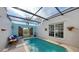 Enclosed private pool with covered patio and seating area at 2402 Palmetto St, Nokomis, FL 34275