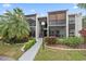 Exterior view of the condo building with landscaping at 3213 Beneva Rd # 201, Sarasota, FL 34232