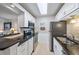 Updated kitchen with white cabinets, granite counters, and stainless steel appliances at 3213 Beneva Rd # 201, Sarasota, FL 34232