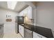 Updated kitchen with white cabinets, granite counters, and stainless steel appliances at 3213 Beneva Rd # 201, Sarasota, FL 34232