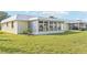 Well-maintained grassy backyard with a sunroom at 5891 Tidewood Ave # 1, Sarasota, FL 34231