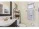 Clean bathroom with a single sink vanity and shower at 5891 Tidewood Ave # 1, Sarasota, FL 34231