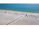 Aerial view of a crowded beach with clear water at 5891 Tidewood Ave # 1, Sarasota, FL 34231