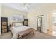Well-lit bedroom with a wooden bench at the foot of the bed at 5891 Tidewood Ave # 1, Sarasota, FL 34231