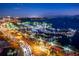 Night view of a marina with boats and city lights at 5891 Tidewood Ave # 1, Sarasota, FL 34231