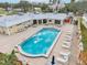 Community pool with surrounding lounge chairs and patio area at 5891 Tidewood Ave # 1, Sarasota, FL 34231