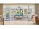 Relaxing screened porch with wicker furniture and serene views at 5891 Tidewood Ave # 1, Sarasota, FL 34231