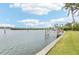 Scenic waterfront view with a private dock and lush greenery at 5891 Tidewood Ave # 1, Sarasota, FL 34231