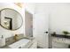 Bright bathroom with a gold faucet and an oval mirror at 6305 Royal Tern Cir, Lakewood Ranch, FL 34202