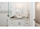 Elegant bathroom with white cabinets, granite countertop, and a frameless shower at 6305 Royal Tern Cir, Lakewood Ranch, FL 34202