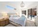 Main bedroom with plush bed, sitting area, and sliding doors to the pool at 6305 Royal Tern Cir, Lakewood Ranch, FL 34202