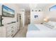 Spacious bedroom with large TV, dresser and access to en-suite bathroom at 6305 Royal Tern Cir, Lakewood Ranch, FL 34202