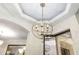Elegant globe chandelier illuminates a spacious entryway or dining area at 6305 Royal Tern Cir, Lakewood Ranch, FL 34202