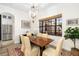 Elegant dining room featuring a rustic table and chandelier at 6305 Royal Tern Cir, Lakewood Ranch, FL 34202