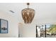 Dining room with a unique beaded chandelier and sliding glass doors at 6305 Royal Tern Cir, Lakewood Ranch, FL 34202