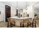 Modern kitchen with white and dark wood cabinets and a large island at 6305 Royal Tern Cir, Lakewood Ranch, FL 34202
