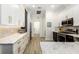 Spacious kitchen boasts modern white cabinets, marble countertops, and a breakfast bar at 6305 Royal Tern Cir, Lakewood Ranch, FL 34202