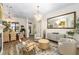 Bright and airy living room with comfortable seating and a large mirror at 6305 Royal Tern Cir, Lakewood Ranch, FL 34202