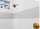 Modern shower with patterned tile and gold fixtures at 6305 Royal Tern Cir, Lakewood Ranch, FL 34202