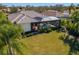 Home with pool and screened enclosure, surrounded by lush landscaping at 7112 Saint Johns Way, University Park, FL 34201