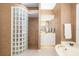 Spa-like bathroom with a large glass block shower and soaking tub at 7112 Saint Johns Way, University Park, FL 34201