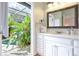 Bathroom with white vanity, view of pool area at 8224 Country Oaks Ct, Sarasota, FL 34243