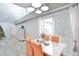 Bright dining room with orange chairs and view to backyard at 8224 Country Oaks Ct, Sarasota, FL 34243